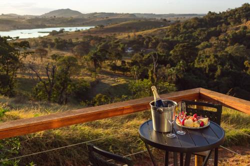 a table with a bowl of fruit and a drink at Entre Serras & Águas in Capitólio