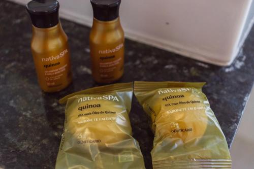 two bottles of mustard and a bag of food on a counter at Entre Serras & Águas in Capitólio