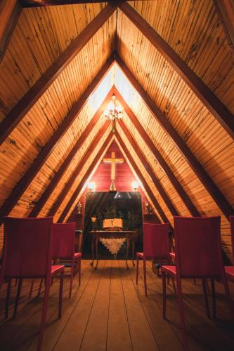 a room with chairs and a piano in a attic at Entre Serras & Águas in Capitólio