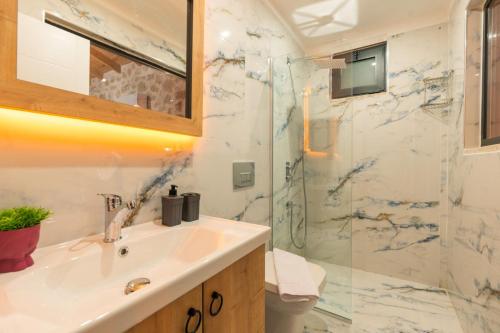 a bathroom with a sink and a shower at Villa estrella in Kaş