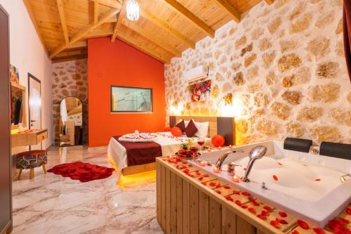 a large room with a tub and a bedroom at Villa estrella in Kaş
