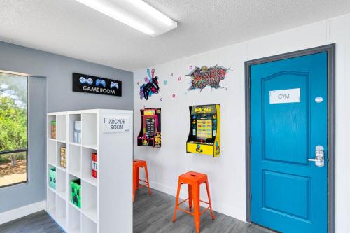 a room with a blue door and two stools at Oasis 201 - Dune Dream in Titusville
