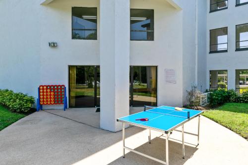 a ping pong table in front of a building at Oasis 201 - Dune Dream in Titusville