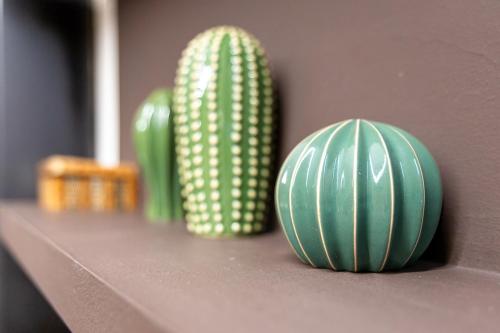 two green vases are sitting on a shelf at Cerca del Puente Tibetano I Tríplex con Vistas in Canillo