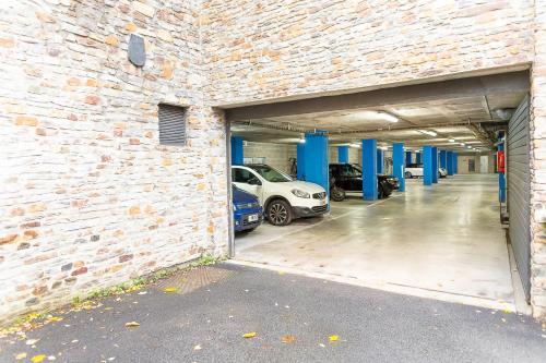 a garage with cars parked inside of a brick building at Cerca del Puente Tibetano I Tríplex con Vistas in Canillo