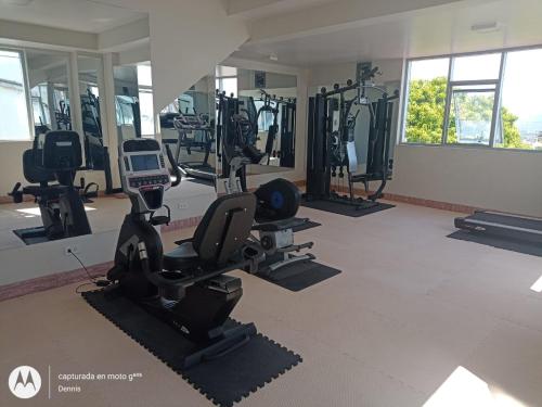 a gym with treadmills and ellipticals in a room at Riosol Hotel Tarapoto in Tarapoto