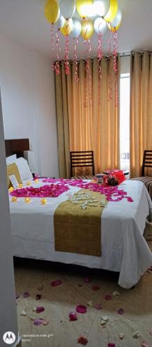 a bedroom with a large bed with flowers on the floor at Riosol Hotel Tarapoto in Tarapoto