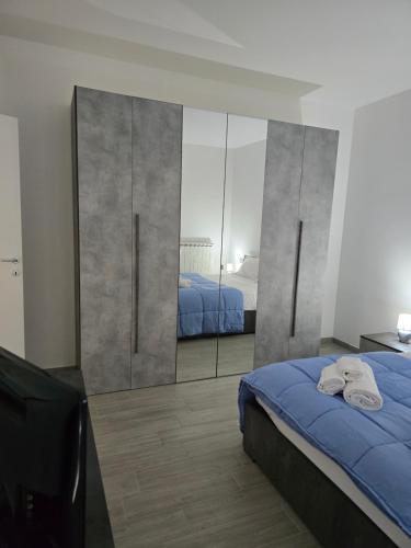 a bedroom with a bed and a large mirror at Deluxe apartment Fiumicino near airport, free parking in Isola Sacra