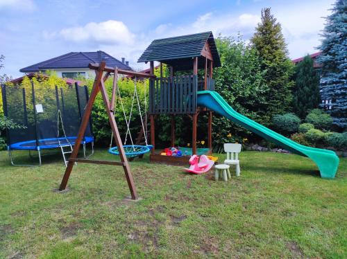 a playground with a slide in a yard at pod lipą in Ustka