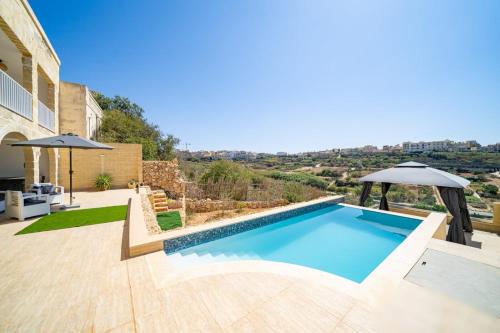 an image of a swimming pool in a villa at The Cave Apartment Xaghra in Xagħra