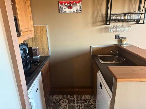 une petite cuisine avec un évier et une cuisinière dans l'établissement Résidence Valeriane - La Valériane 203 - Très beau 2 pièces avec vue dégagée sur la vallée MAE-1474, à Valmorel