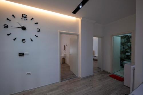 a large clock on a wall in a room at Vila Mario in Ksamil
