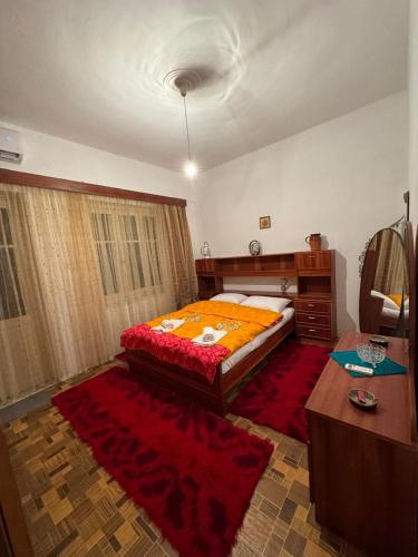 a bedroom with a bed and a dresser and a table at Το σπίτι της γιαγιάς in Paramythia