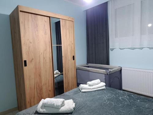 a bedroom with a bed with towels on it at Vision Apartment "self check in" Thessaloniki in Thessaloniki