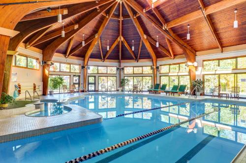 an indoor pool with a large room with wooden ceilings at The Woods - Village-40 in Killington