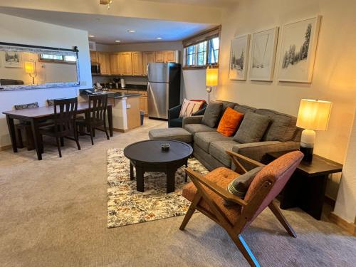 a living room with a couch and a table at Ski in Ski out Resort Breckenridge 1BR 2Beds Parking, Resort Shuttle & Amenities in Breckenridge