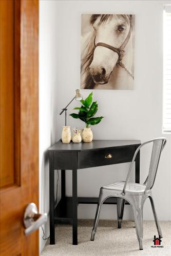 a black desk with a horse picture on the wall at Sonoran Desert Getaway with Cowboy Tub in Cave Creek