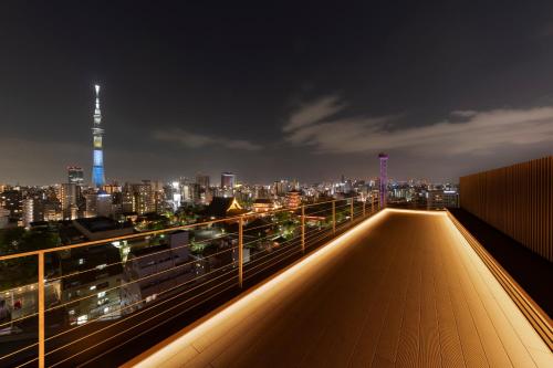 a view of a city skyline at night at The Kanzashi Tokyo Asakusa in Tokyo