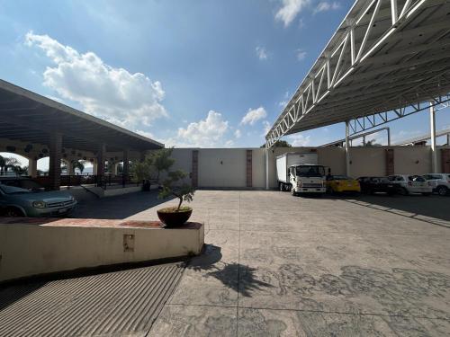 a large parking lot with cars parked in it at Hotel Posada Virreyes in Guadalajara