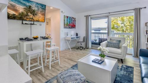 a living room with a couch and a table at Soul of Duval by Last Key Realty in Key West