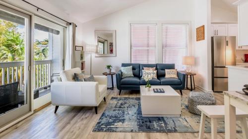 a living room with a couch and a table at Soul of Duval by Last Key Realty in Key West