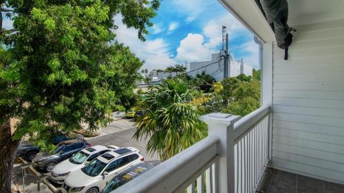 a balcony of a house with cars parked in a parking lot at Soul of Duval by Last Key Realty in Key West
