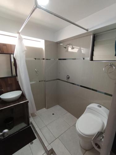 a bathroom with a toilet and a sink at Hidden Garden in Cusco