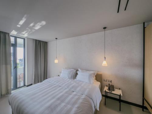 Ένα ή περισσότερα κρεβάτια σε δωμάτιο στο Zins Luxury Rooms