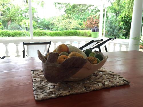 a bowl of fruit sitting on top of a table at Coral House SAI in El Cove