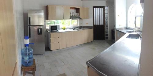 a kitchen with a stainless steel refrigerator and a sink at Coral House SAI in El Cove