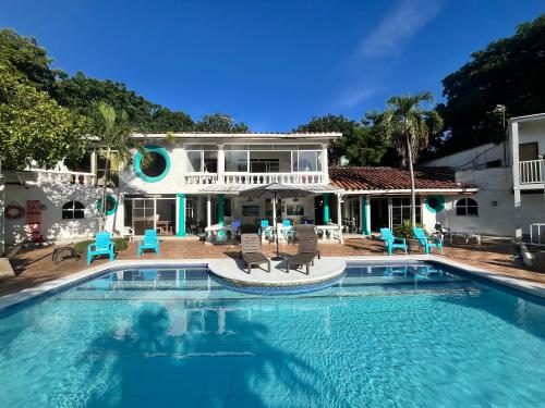 a large swimming pool in front of a house at Coral House SAI in El Cove