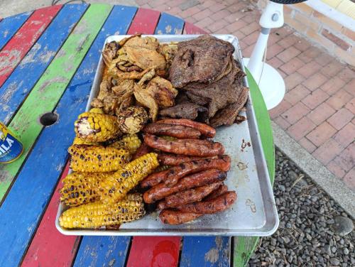 a tray of sausages and other foods on a table at Quinta de San Pedro in Villavicencio