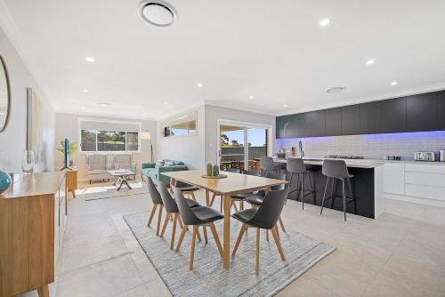 a kitchen and dining room with a table and chairs at Devan House - An Entertainers' Retreat Close to Town in Mudgee