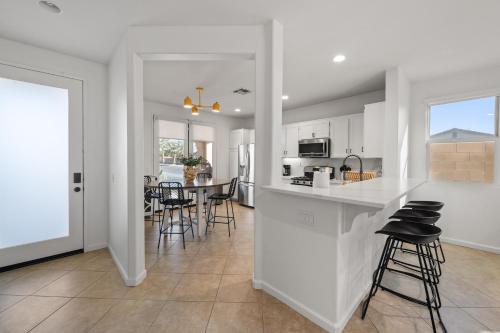 a kitchen and dining room with a table and chairs at Casa Desert Muse with Heated Pool Spa Firepit Mini Golf and Games in Indio
