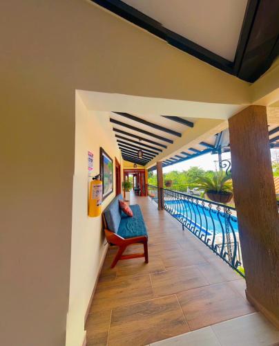 a living room with a couch and a balcony at Hotel Campestre Villa Salome in Quimbaya