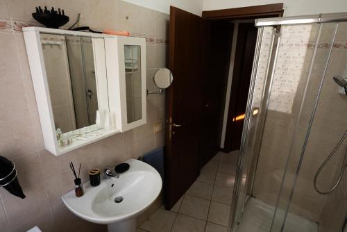 a bathroom with a sink and a shower at Garibaldi 26 in Stresa
