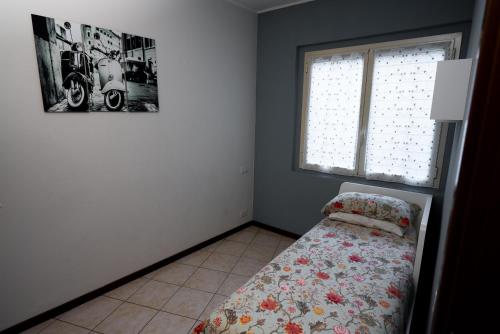 a bedroom with a bed and a window at Garibaldi 26 in Stresa