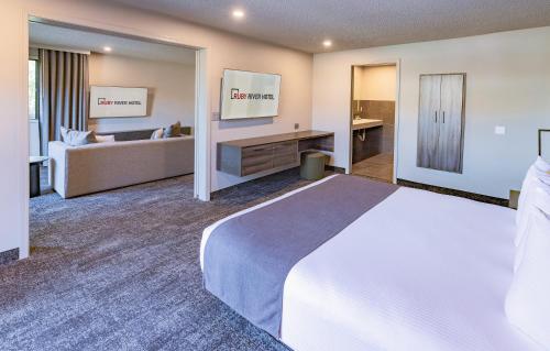 a hotel room with a large bed and a couch at Ruby River Hotel in Spokane