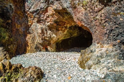 a cave in the side of a large rock at Cozzy Cabin at "Explore-Cafe & Lodge" Located in Duhatao, Chiloe Island, Patagonia, Chile in Ancud