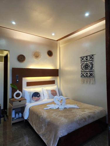 a bedroom with a large bed with towels on it at Inngo Tourist Inn in El Nido