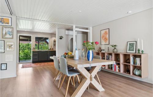 a dining room with a wooden table and chairs at Beautiful Home In Fredensborg With Wifi in Fredensborg
