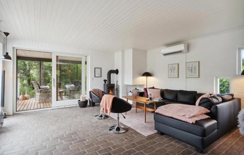 a living room with a couch and a table at Three-Bedroom Holiday Home Thyholm With A Fireplace 06 in Sønder Ydby