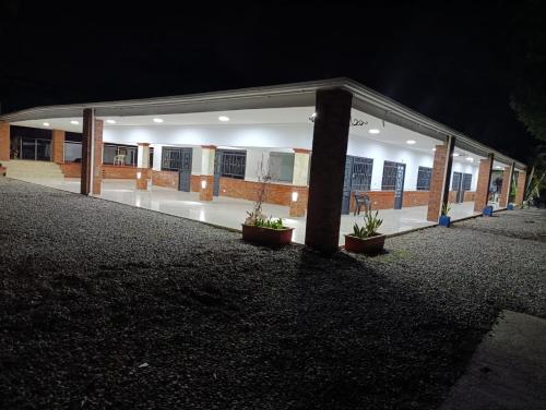 a building at night with potted plants in front of it at Quinta de san pedro in Villavicencio