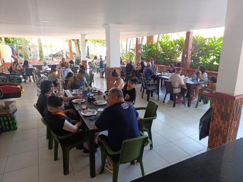 a group of people sitting at tables in a restaurant at Quinta de san pedro in Villavicencio