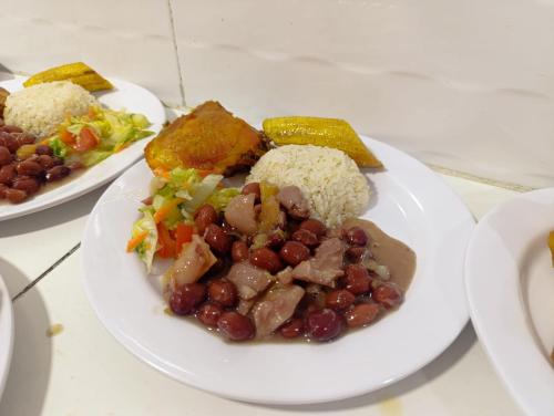 a plate of food with beans and vegetables on a table at Quinta de san pedro in Villavicencio