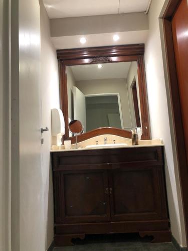 a bathroom with a sink and a large mirror at Puente de la Mujer in Buenos Aires