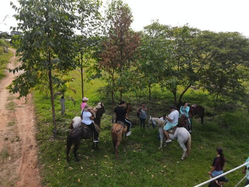 a group of people riding horses on a dirt road at Finca Ecoturistica Piedra Alta in Puerto Arturo