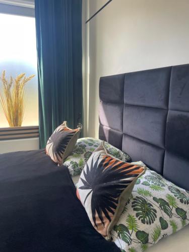a bedroom with a bed with two pillows on it at MoryńApartments ROOMS in Moryń
