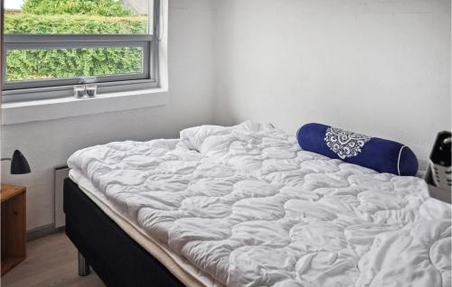 an unmade bed in a room with a window at Three-Bedroom Holiday Home In Nyborg in Nyborg