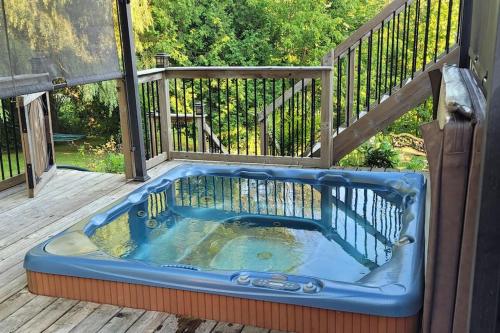 a jacuzzi tub sitting on a deck at Summer Getaway with Pool and Nearby Attractions in Cobourg